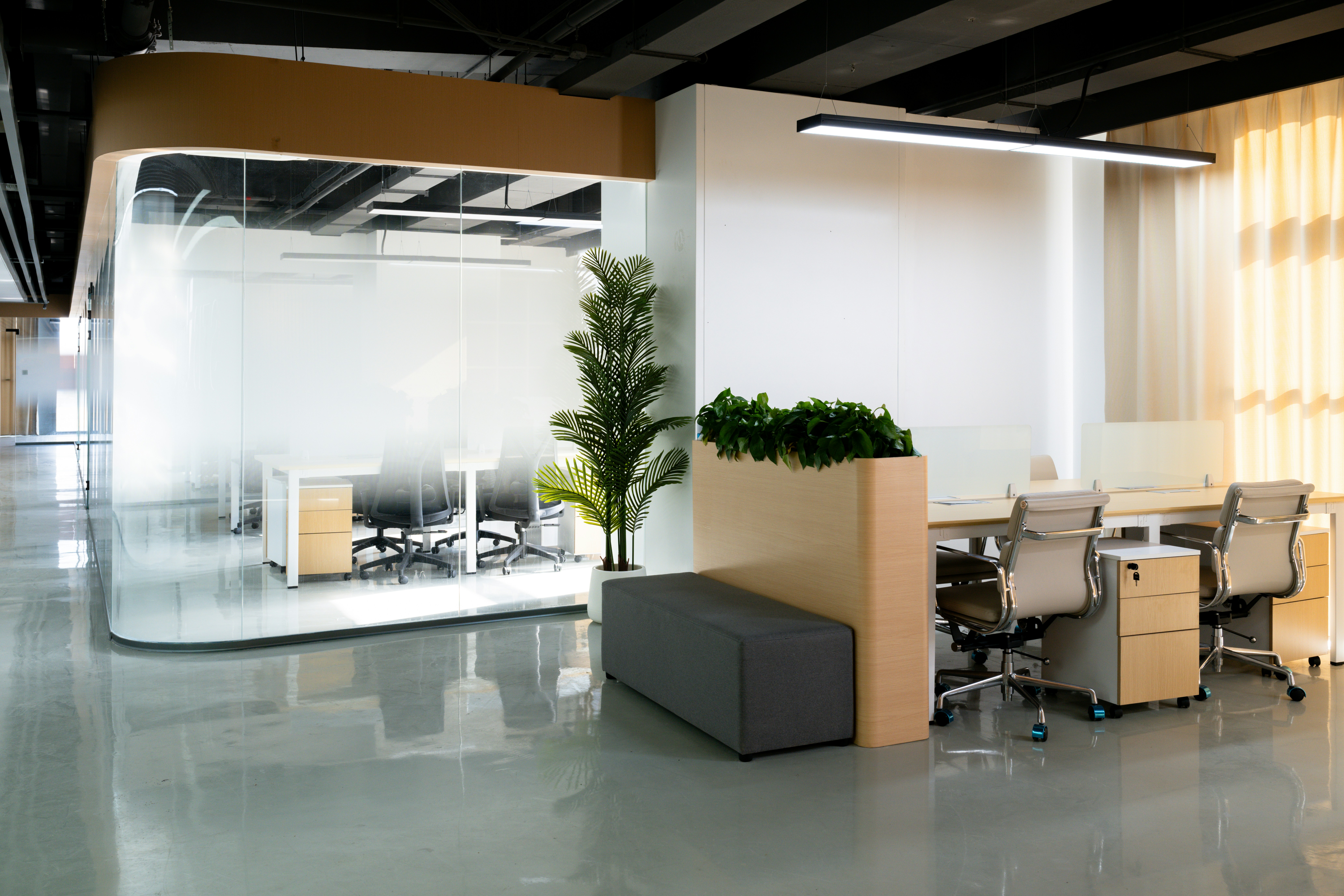 A stylish restaurant interior featuring a central tree, elegant furniture, and warm lighting.