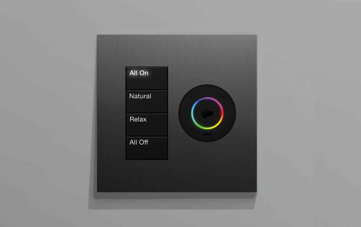 Modern wall-mounted smart lighting control panel with four labeled buttons and a circular color selector.
